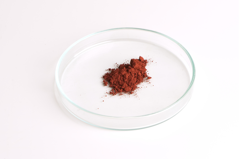 Iron III oxide powder in a glass petri dish